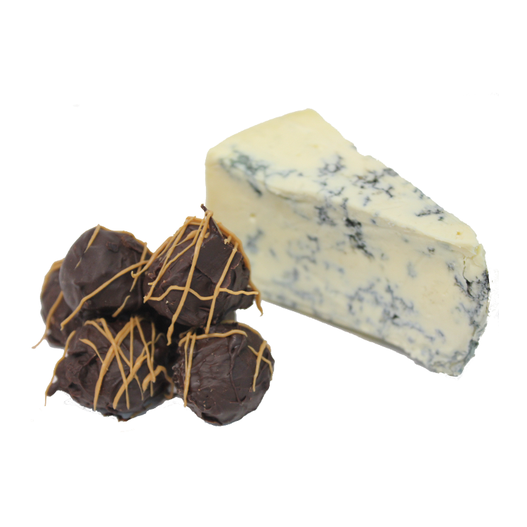 A stack of chocolate truffles with blue vein cheese centre sitting next to a chunk of blue vein cheese