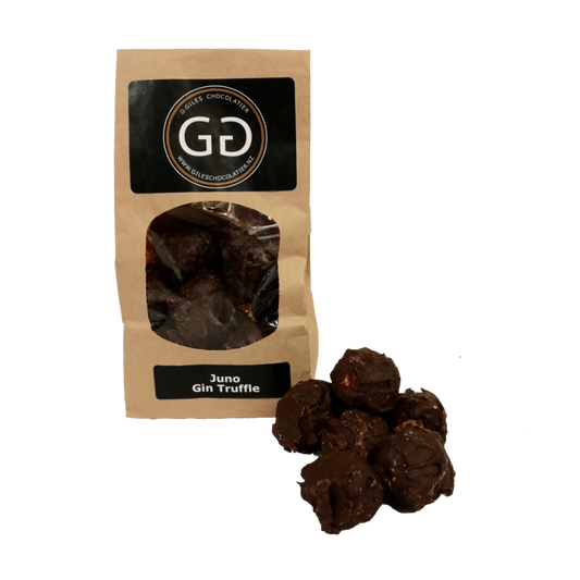 Pile of Juno Gin truffle next to a Giles chocolatier bag filled with scrumptious juno Gin truffles