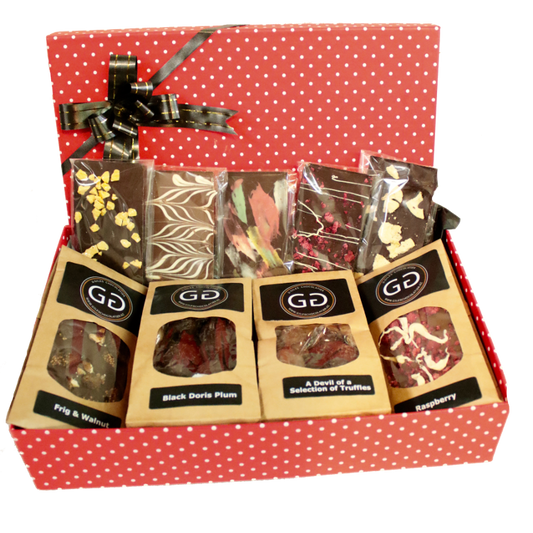 Red spotted box full with different chocolate bars and truffles from Giles Chocolatier