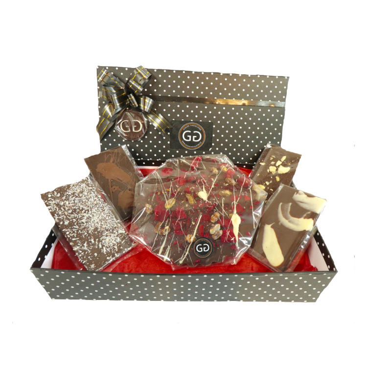 Black spotted box full with different chocolate bars and truffles from Giles Chocolatier