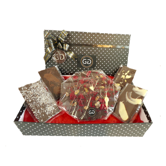 Black spotted box full with different chocolate bars and truffles from Giles Chocolatier
