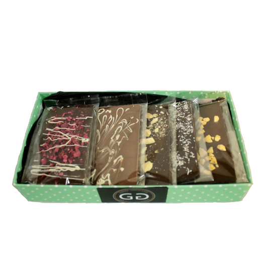 Green spotted box full with different chocolate bars and truffles from Giles Chocolatier