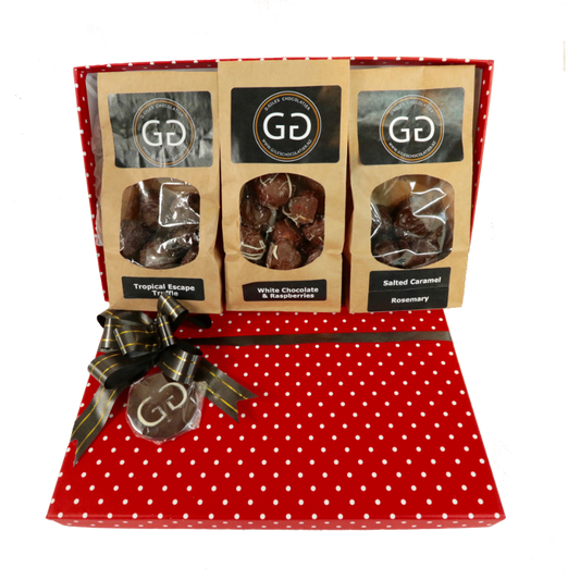 Red spotted box full with different chocolate bars and truffles from Giles Chocolatier