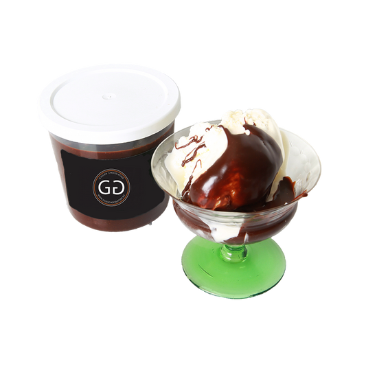 Chocolate Sauce in a giles choclatier container next to a glass containing ice cream drizzled with chocolate sauce