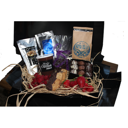 A selection of Giles Chocolatier items showcased in a black box with black lid