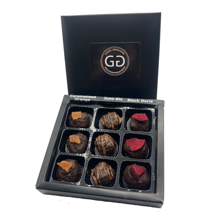 Black box of 9 chocolate bon bons with lid showing Giles chocolatier logo