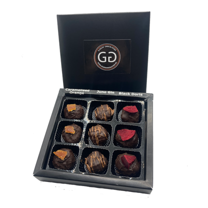 Black box of 9 chocolate bon bons with lid showing Giles chocolatier logo