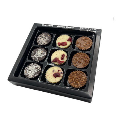 Black box containing 9 chocolate bon bons three different flavours on in each row