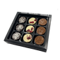 Black box containing 9 chocolate bon bons three different flavours on in each row