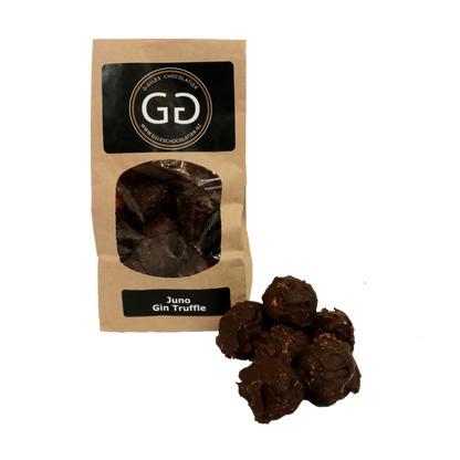 Pile of Juno Gin truffle next to a Giles chocolatier bag filled with scrumptious juno Gin truffles