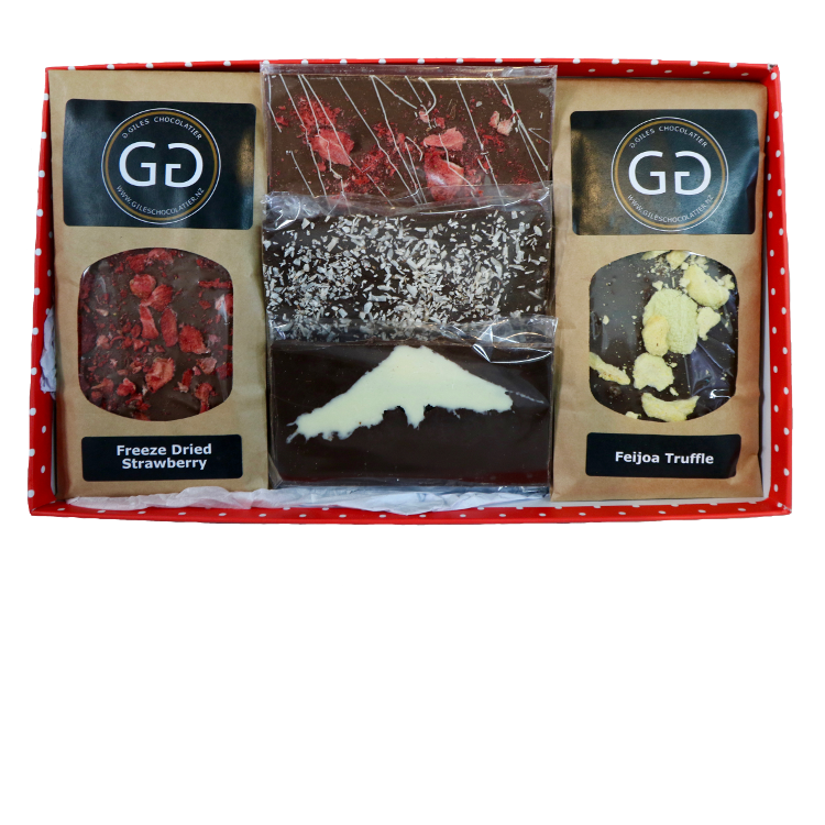 Red spotted box containing a mixture of Giles chocolatier bars and truffles