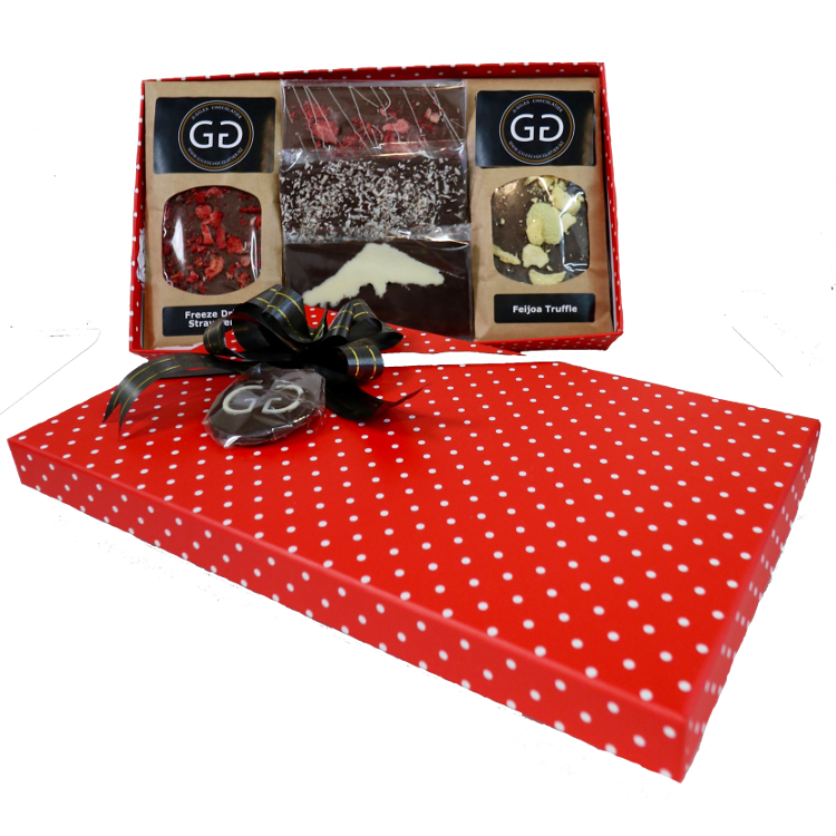 Red spotted box full with different chocolate bars and truffles from Giles Chocolatier