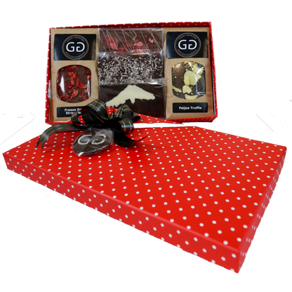 Red spotted box full with different chocolate bars and truffles from Giles Chocolatier