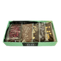 Green spotted box full with different chocolate bars and truffles from Giles Chocolatier