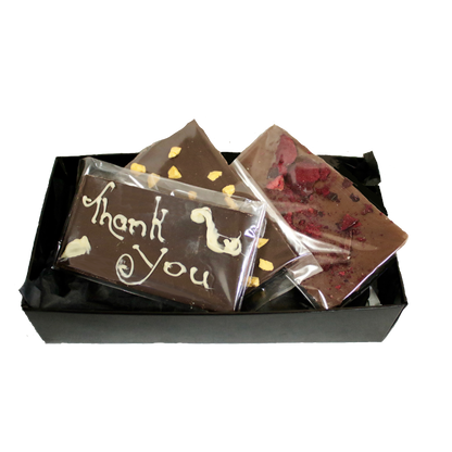 Small black box containing and assortment of three Giles Chocolatier bars