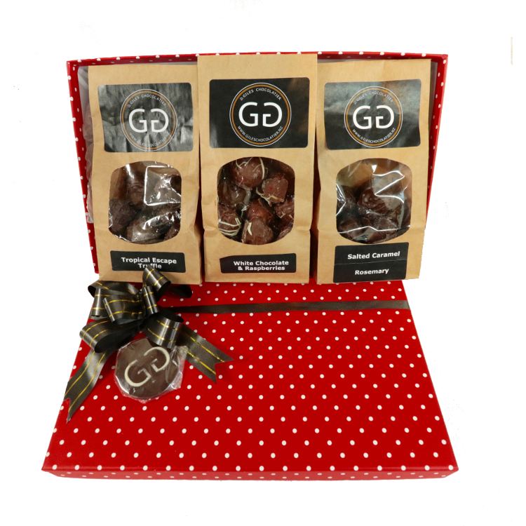 Red spotted box full with different chocolate bars and truffles from Giles Chocolatier
