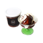 Chocolate Sauce in a giles choclatier container next to  a glass containing ice cream drizzled with chocolate sauce